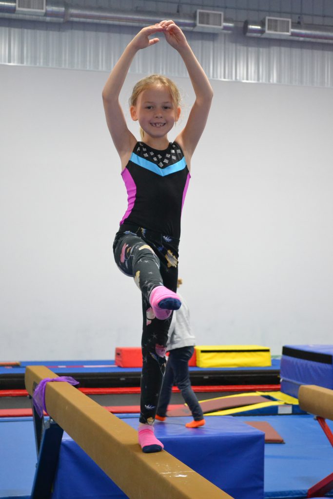A girl on a balance beam