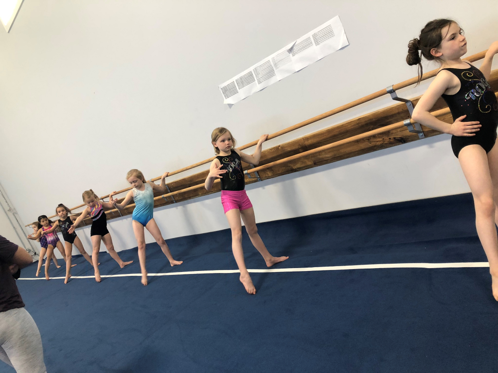 Girls team using barre