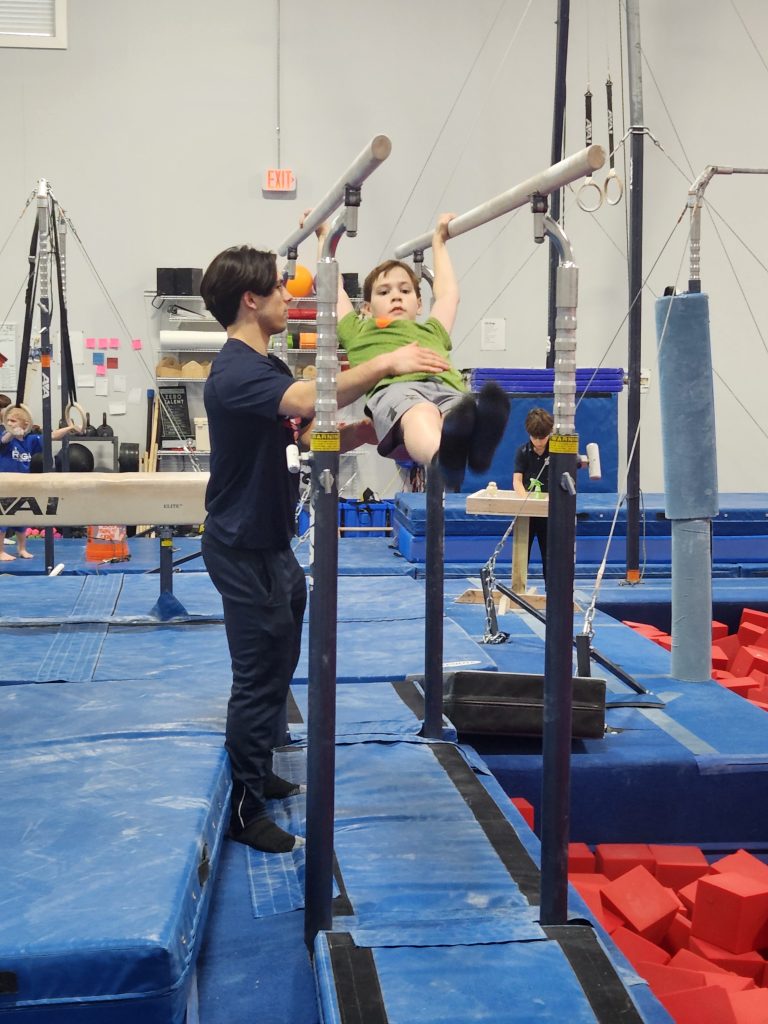 A child working on parallel bars