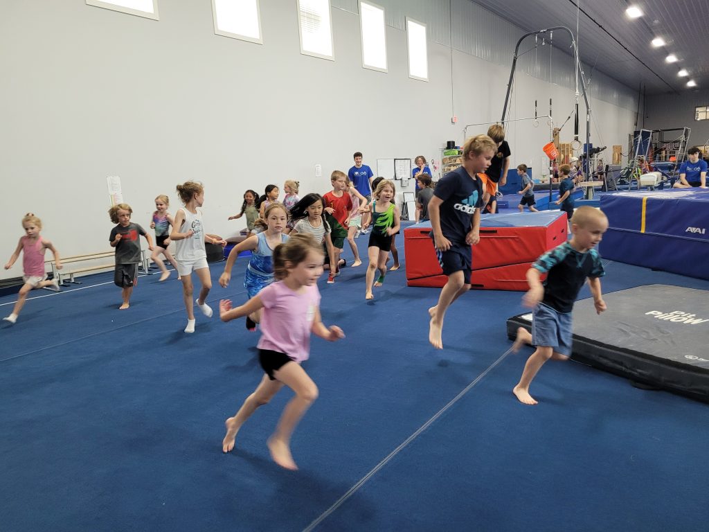 Kids on gymnastics floor at Camp ROGA
