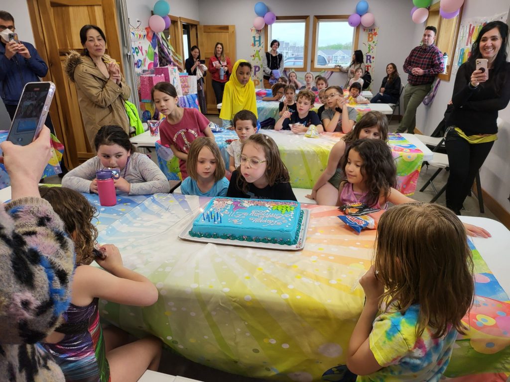 A child with cake in ROGA birthday space