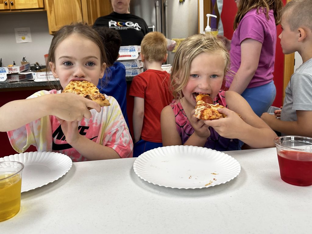 Children eating pizza at Kids Night Out