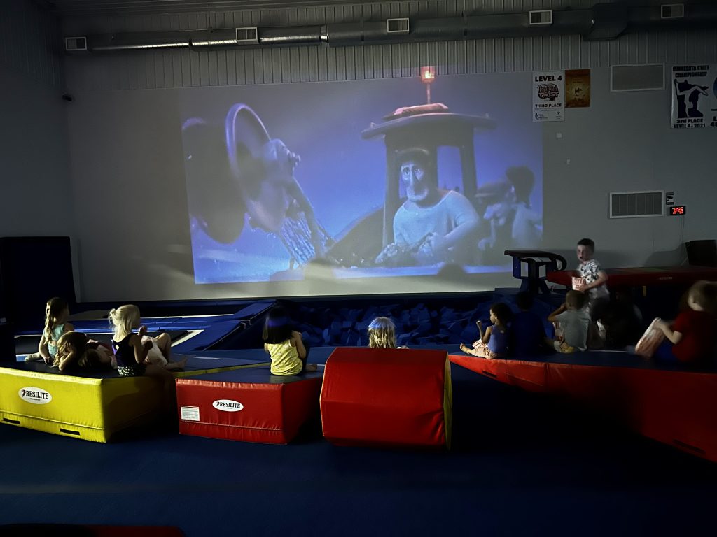 Children watching a movie at Kids Nights Out