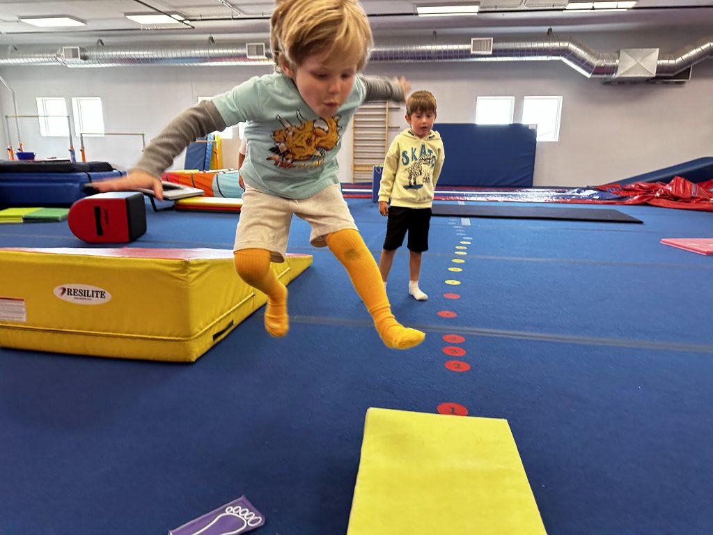 A child jumping on the gymnastics course