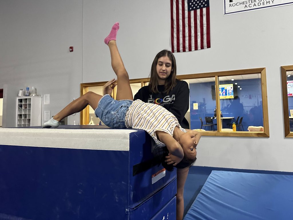 A child practicing a gymnastics movement
