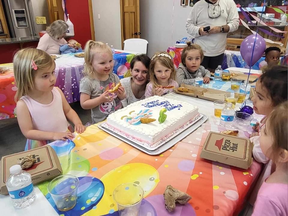 Children about to have cake at a ROGA birthday party