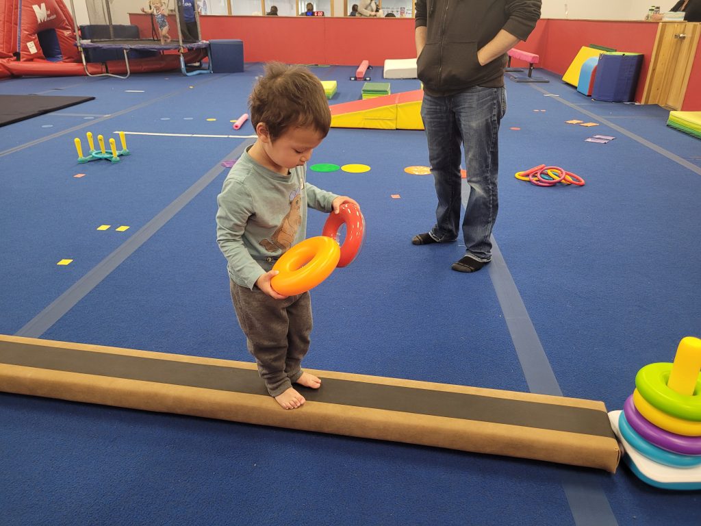 A child practicing a balance beam