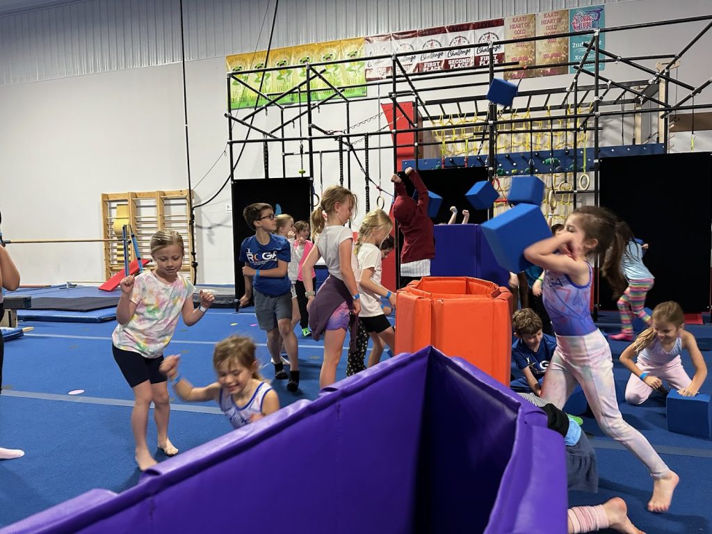 Kids at Camp ROGA jumping in the indoor gymnastics play area