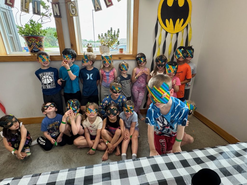 Kids smiling in masks at Camp ROGA