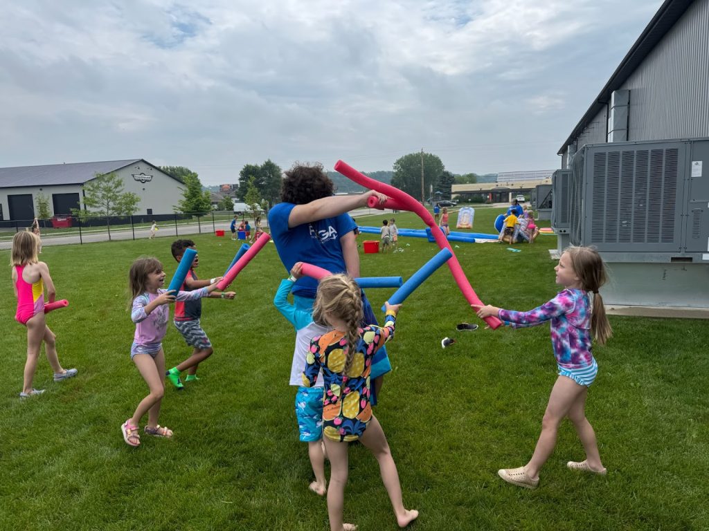 Kids at Camp ROGA having fun battling with pool noodles