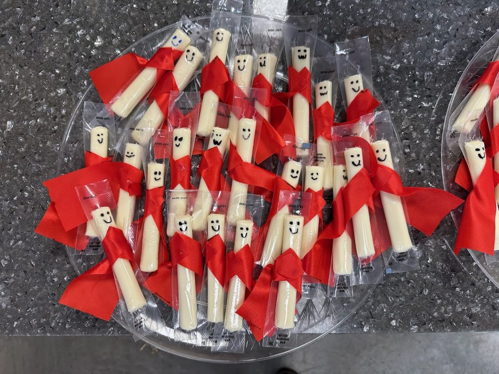 A snack at Camp ROGA featuring string cheese decorated as superhero
