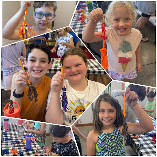 Kids holding up broom craft