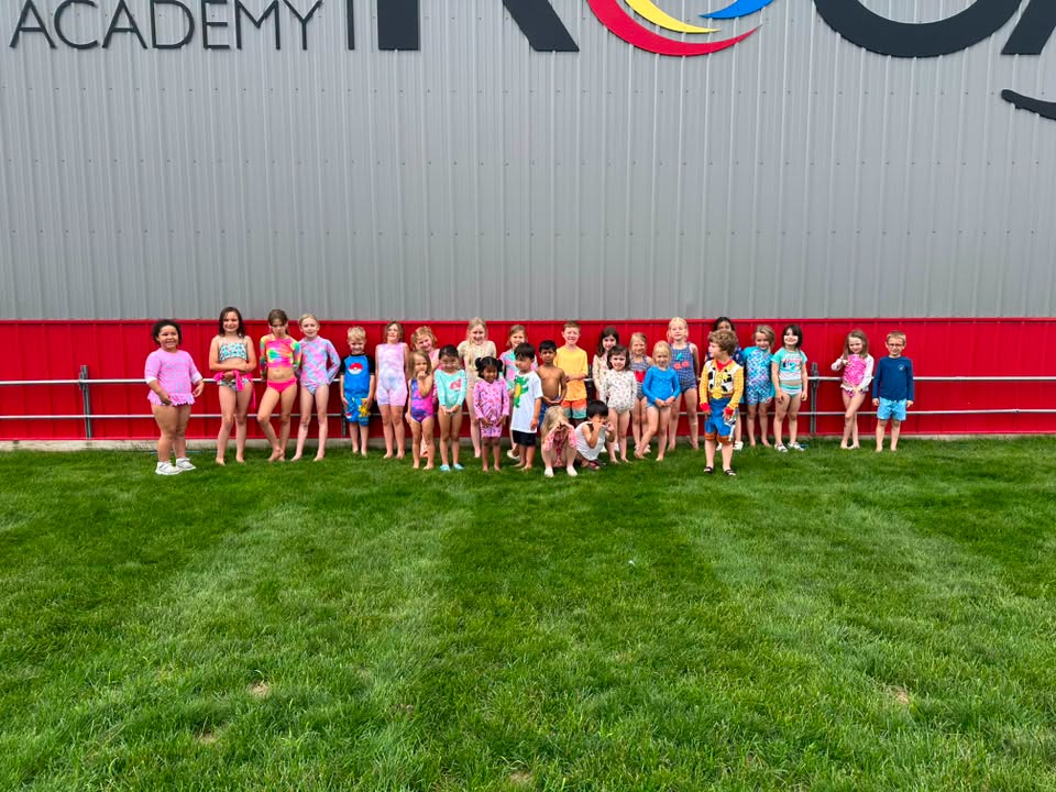 Camp ROGA campers pose together outside after a fun-filled Aquaman-themed Water Day during Superhero Week.